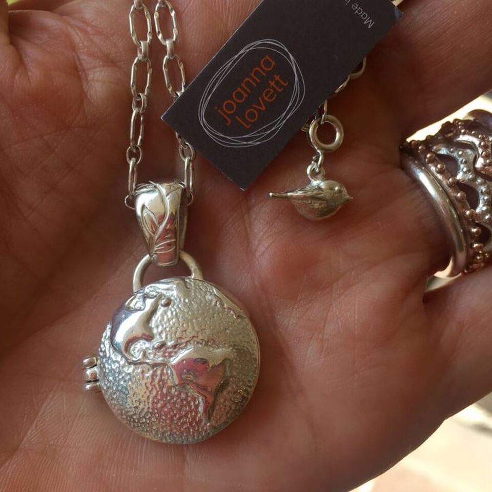 The Earth Locket in sterling silver opens to reveal a private message adn teh inscription 